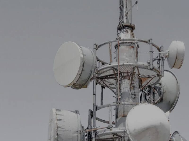 Panning shot of a yellow car in motion on a city street, illustrating dynamic urban mobility